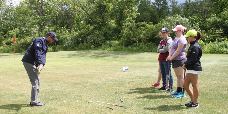 Photo of Dan Rose, Varsity Golf Coach Oswego High School teaching junior golfers at Tamarack Golf Club in Oswego, NY.